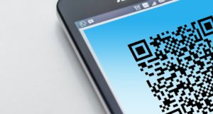 A cell phone shows a QR code to request reviews and improve online reputation