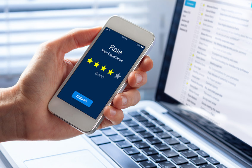 Person rating his experience with stars on smartphone app screen