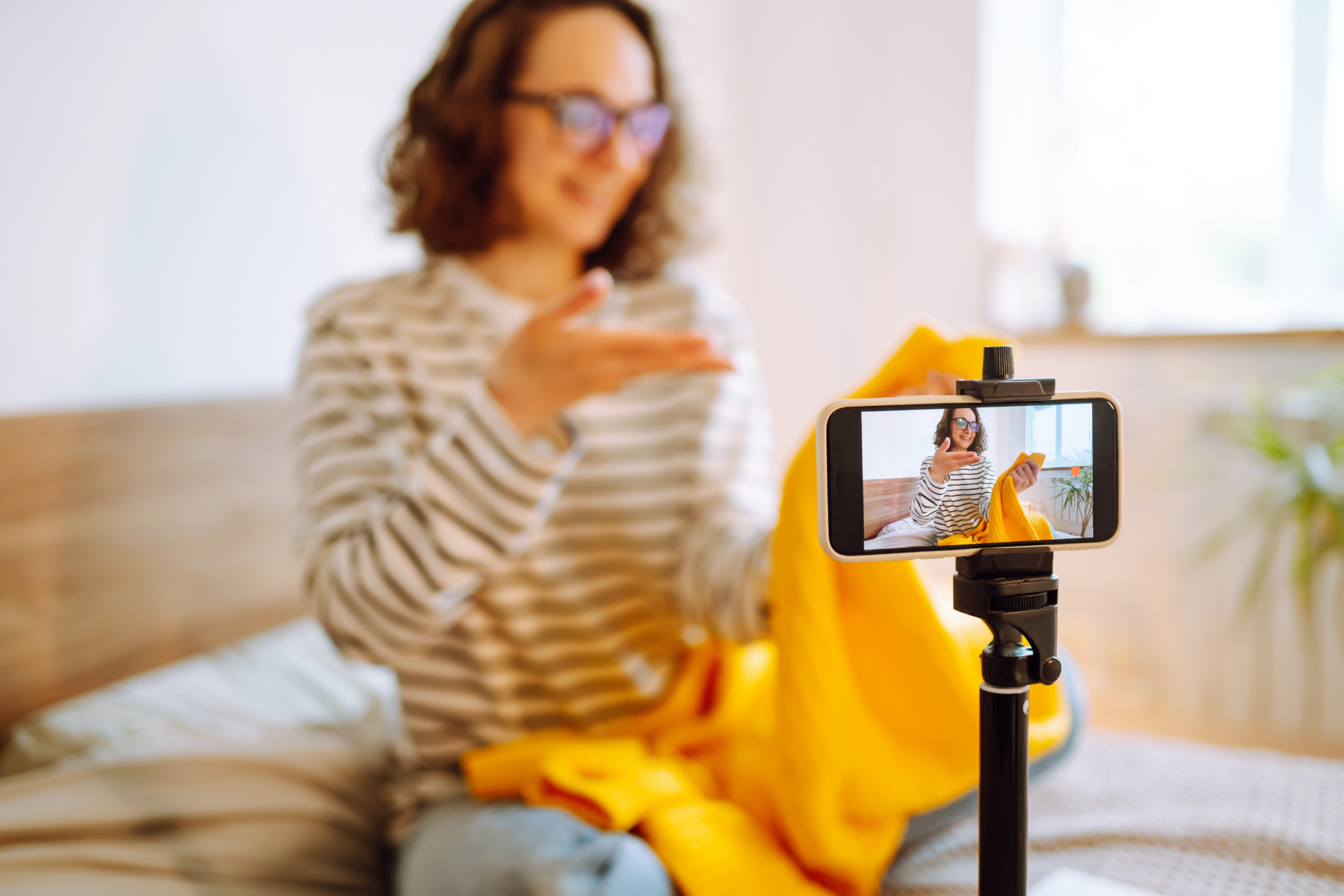 Woman leaving a testimonial video on a cell phone