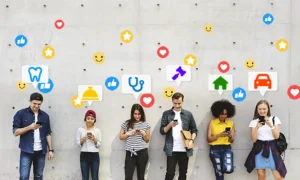 People representing various industry specific review sites against a wall looking at phones