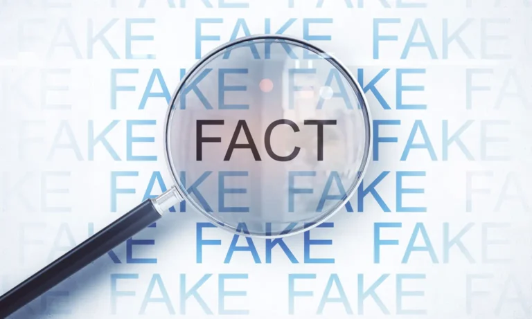 Magnifying glass showing the word 'FACT' over multiple 'FAKE' words, representing the FTC Fake Reviews Rule targeting deceptive practices.