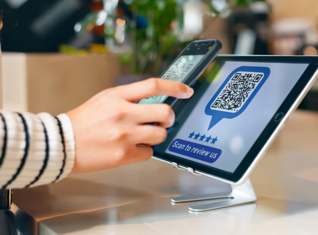 Customer scanning a QR code to leave a Google Review at checkout.
